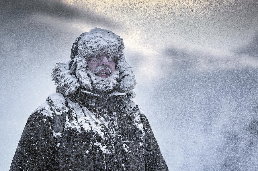 Wintery scene of a man with Furry and full beard shivering in a snow storm Photograph by DieterMeyrl