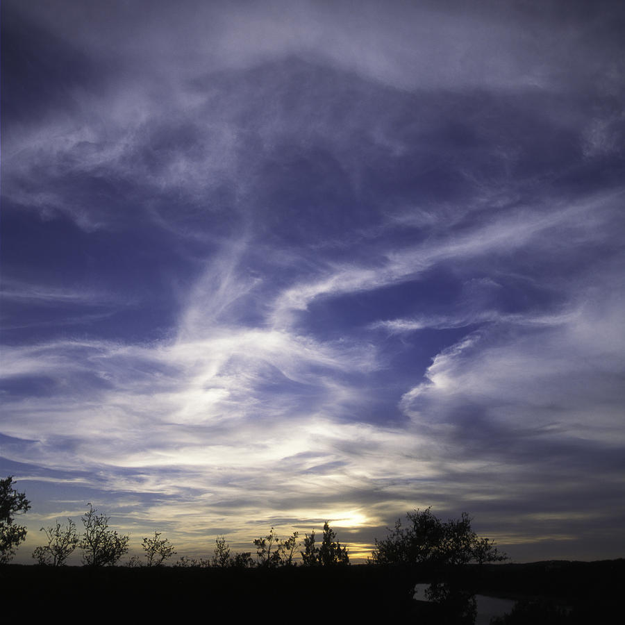 Wispy white clouds against deep blue sky at sunset in central Te Photograph by Alan Tonnesen