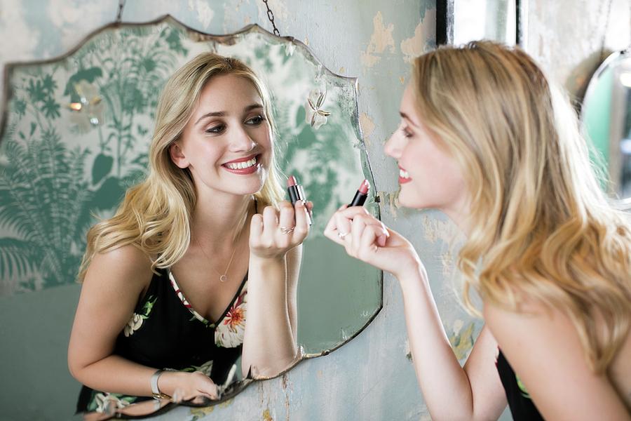 Woman Applying Lipstick In Mirror Photograph By Science Photo Library Fine Art America 3690