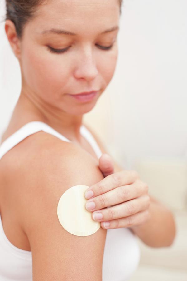 Woman Applying Nicotine Path To Arm Photograph by Science Photo Library