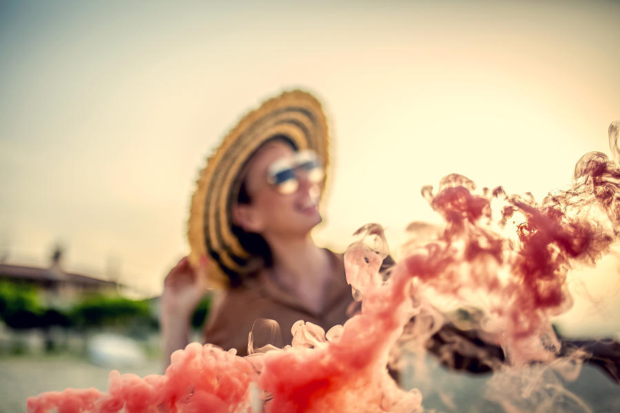 Woman at the beach with smoke bomb Photograph by Jakovo