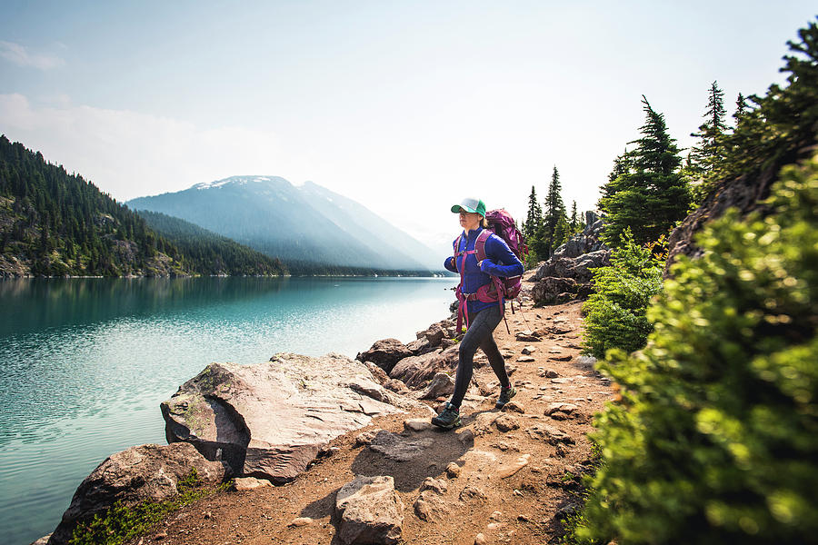 Woman Backpacking Along Shore Of Lake Photograph by Brent Doscher ...