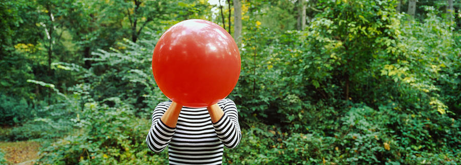 Tree Photograph - Woman Blowing A Balloon, Germany by Panoramic Images