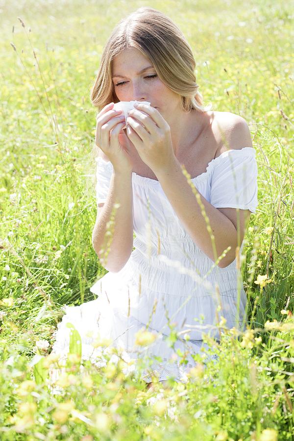 Woman Blowing Nose On Tissue Photograph by Ian Hooton/science Photo Library