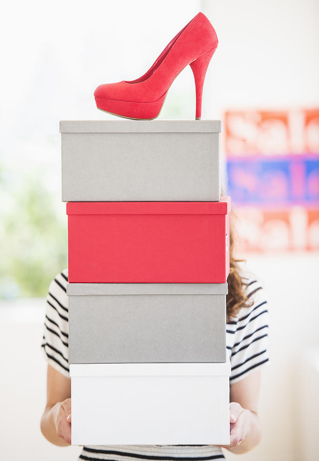 Woman carrying shoes boxes Photograph by Daniel Grill