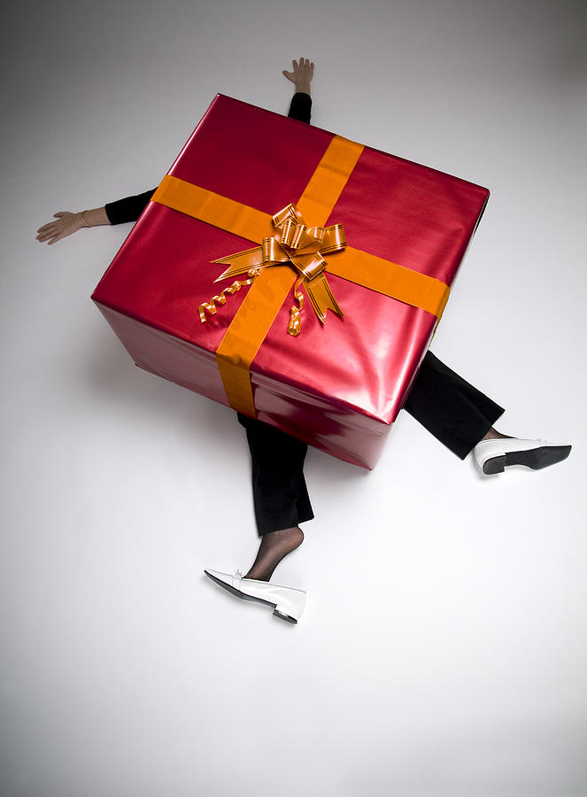 Woman Crushed Beneath Huge Wrapped Present Photograph by Ferrantraite