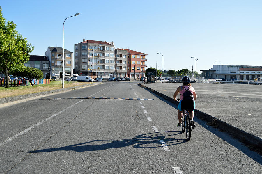 Woman cycling on her bike Photograph by Luis Diaz Devesa