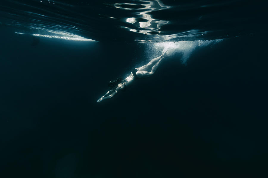 Woman diving into dark water Photograph by Vernonwiley