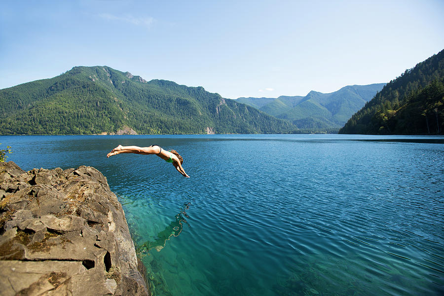 Woman Diving Off A Rock Photograph by Jordan Siemens