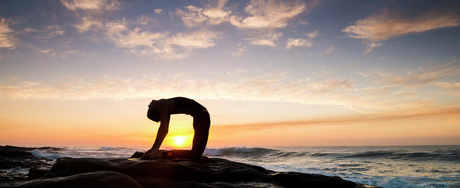 Nature Photograph - Woman Doing Yoga Camel Pose by Panoramic Images