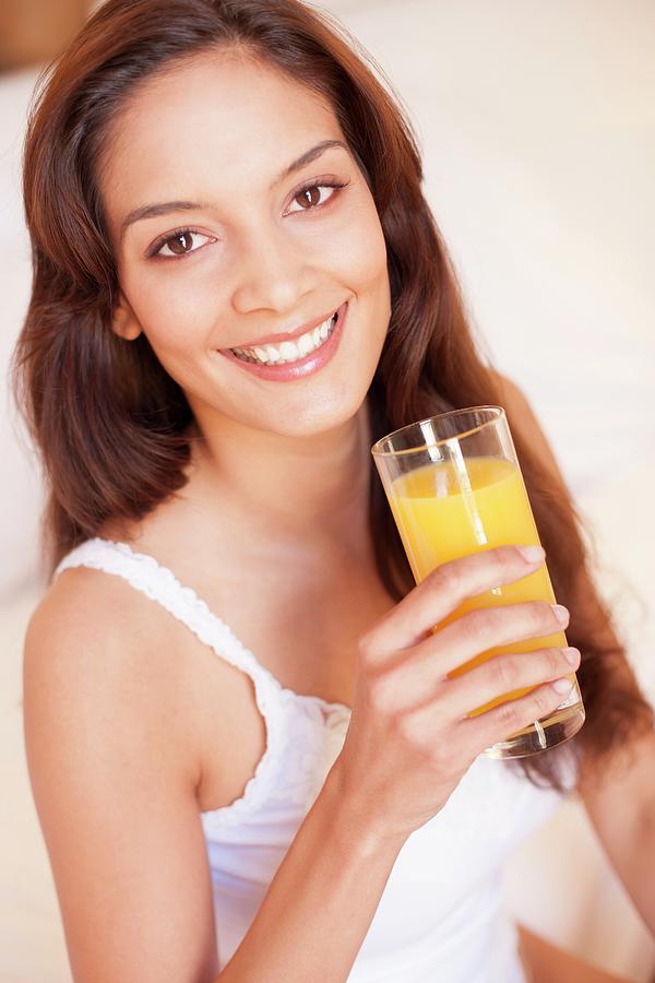 Woman Drinking Fruit Juice Photograph by Ian Hooton/science Photo Library