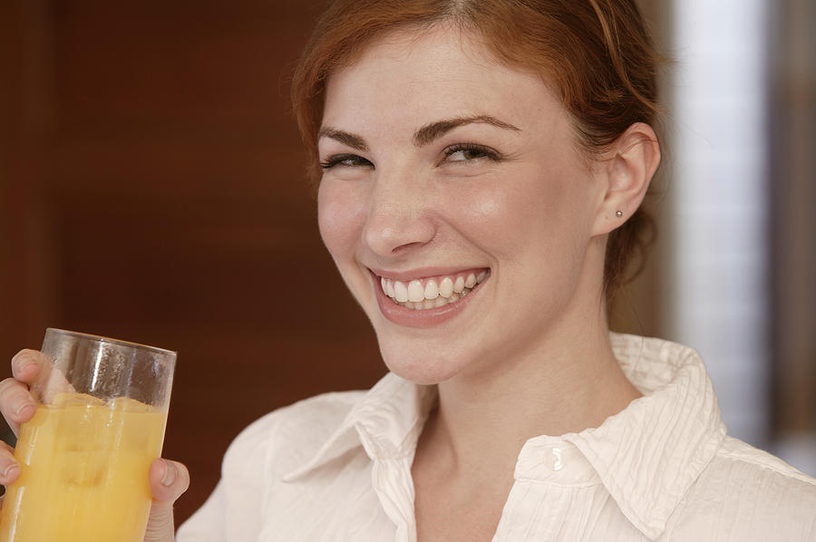 Woman drinking juice Photograph by Comstock Images