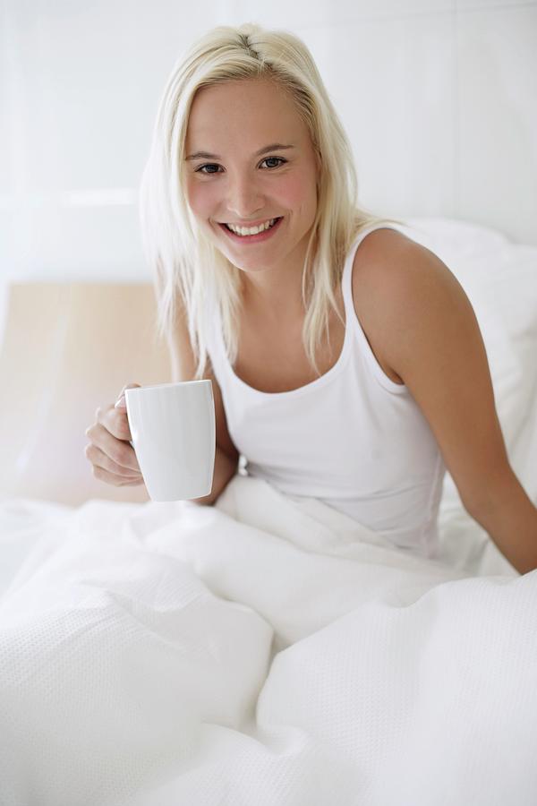 Woman Drinking Tea In Bed Photograph By Ian Hootonscience Photo Library