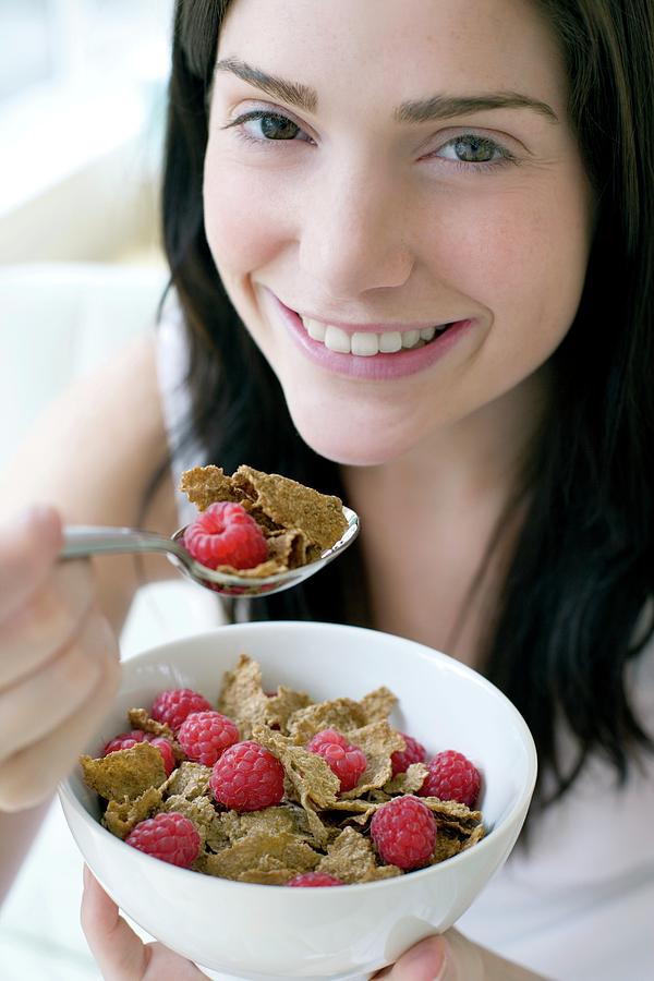 Cereal Photograph - Woman Eating Healthy Cereal by Ian Hooton/science Photo Library