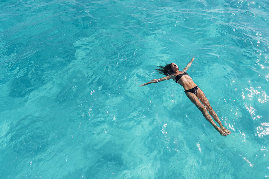 Woman Floating On Her Back, Swimming In Ocean Photograph by Nisian Hughes