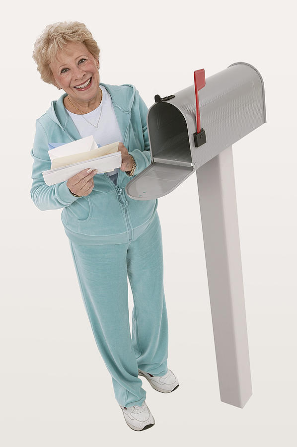 Woman getting mail Photograph by Comstock Images