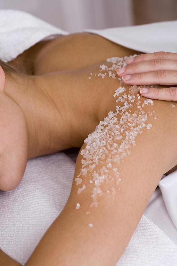 Woman having body scrub rubbed on her back Photograph by Comstock Images