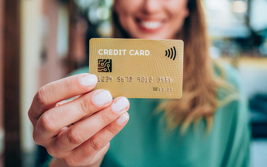 Woman holding a credit card Photograph by VioletaStoimenova