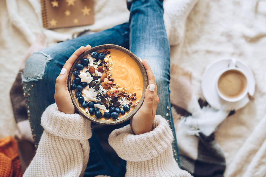 Woman holding a pumpkin smoothie bowl Photograph by Xsandra