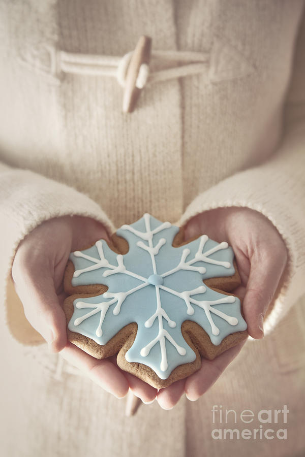 Woman holding a snowflake cookie Photograph by Sandra Cunningham