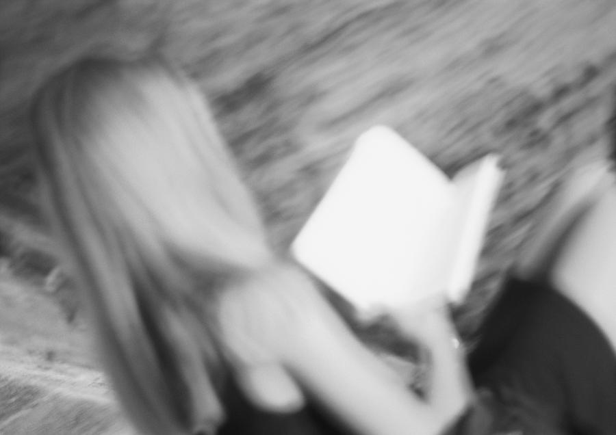 Woman holding book, blurred, b&w Photograph by Frederic Cirou