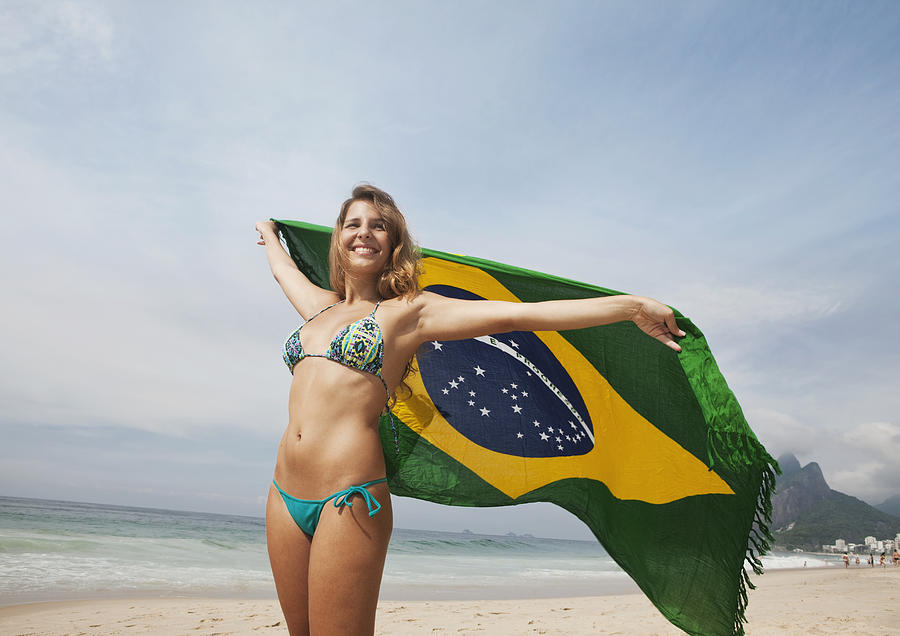 Woman holding Brazil flag at Ipanema beach Photograph by Markus Bernhard