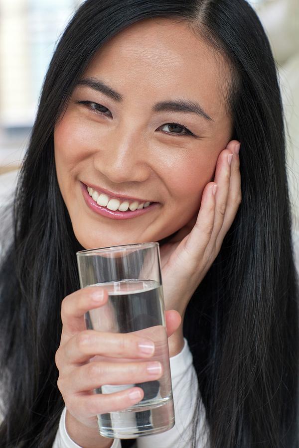 Portrait Photograph - Woman Holding Glass Of Water by Ian Hooton