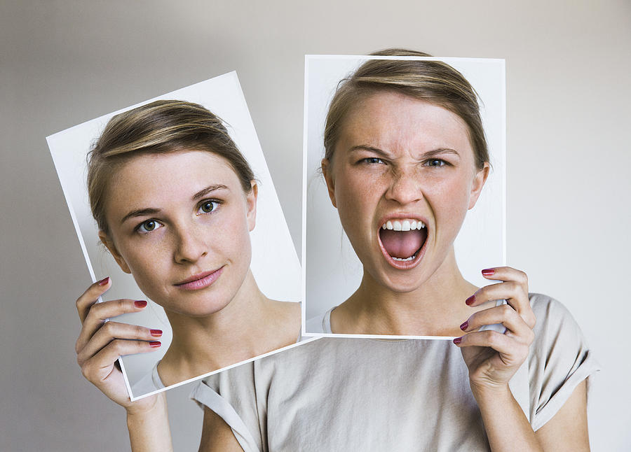 Woman holding happy and angry portraits Photograph by Dimitri Otis