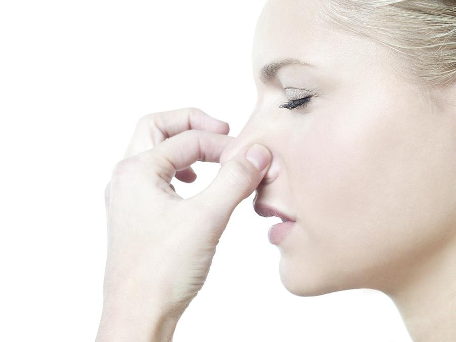 Woman holding her nose Photograph by Science Photo Library