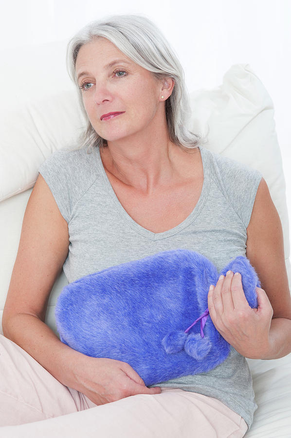 Woman Holding Hot Water Bottle Photograph by Lea Paterson | Fine Art