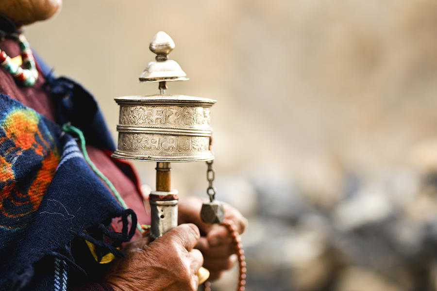 Woman holding prayer wheel and beads Photograph by Triloks