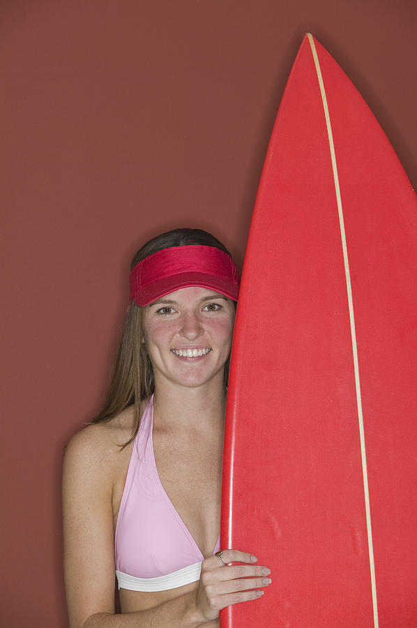 Woman holding surfboard Photograph by Comstock Images