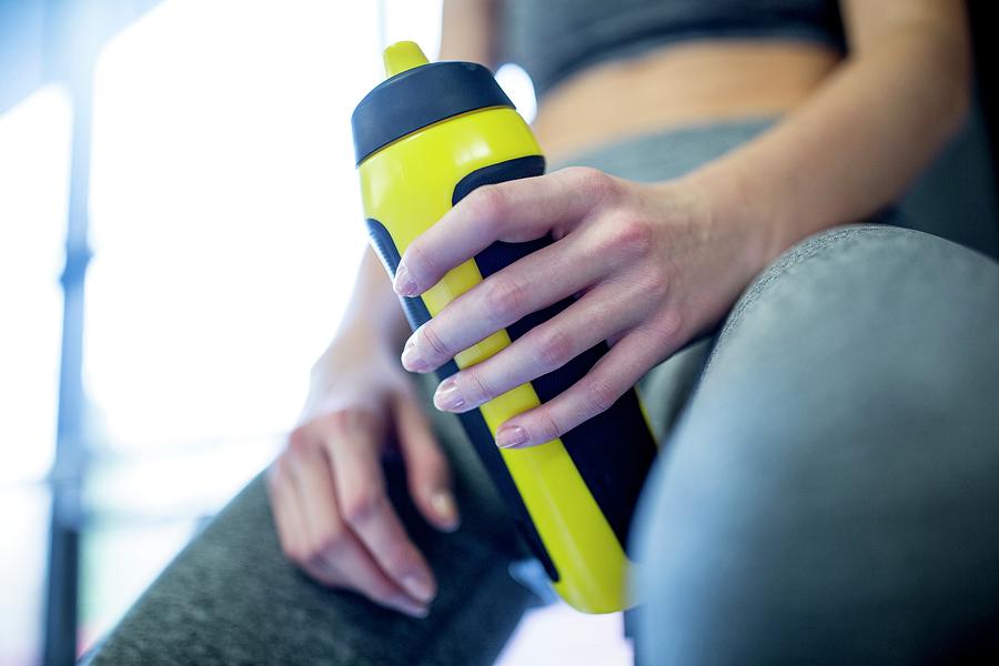 Woman Holding Water Bottle In Gym Photograph by Science Photo Library