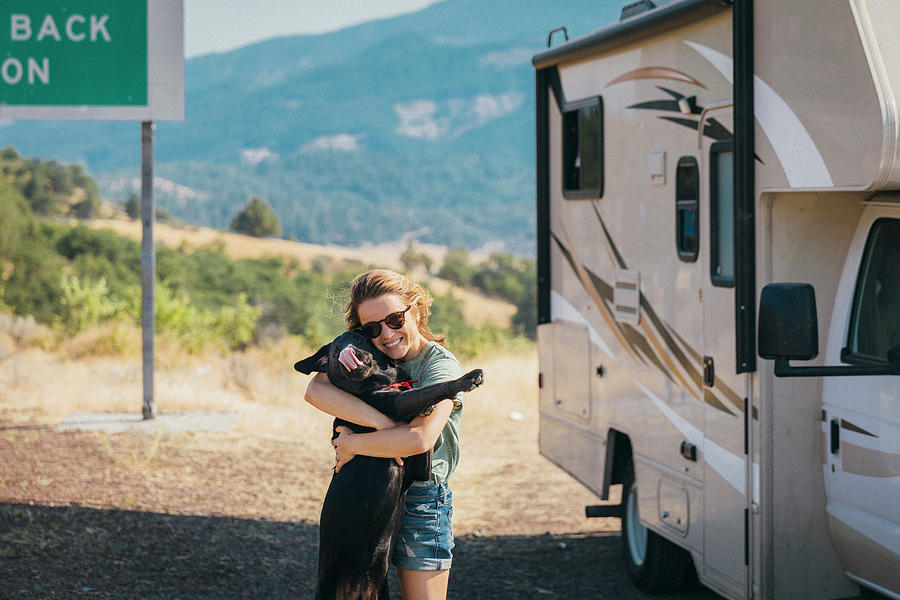 Dog Photograph - Woman Hugging Dog Near Campervan by Evgeny Vasenev