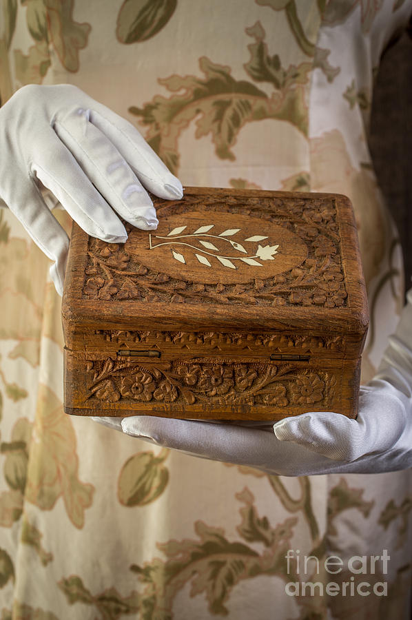 Woman in a dress opening a ornate box Photograph by Edward Fielding