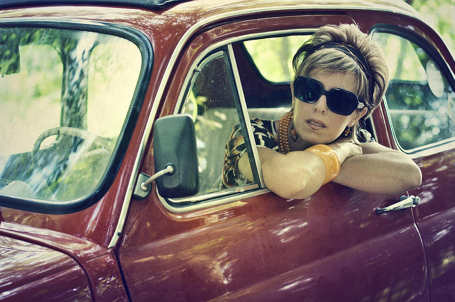 Woman in a vintage italian car. 1970s style. Photograph by SeanShot