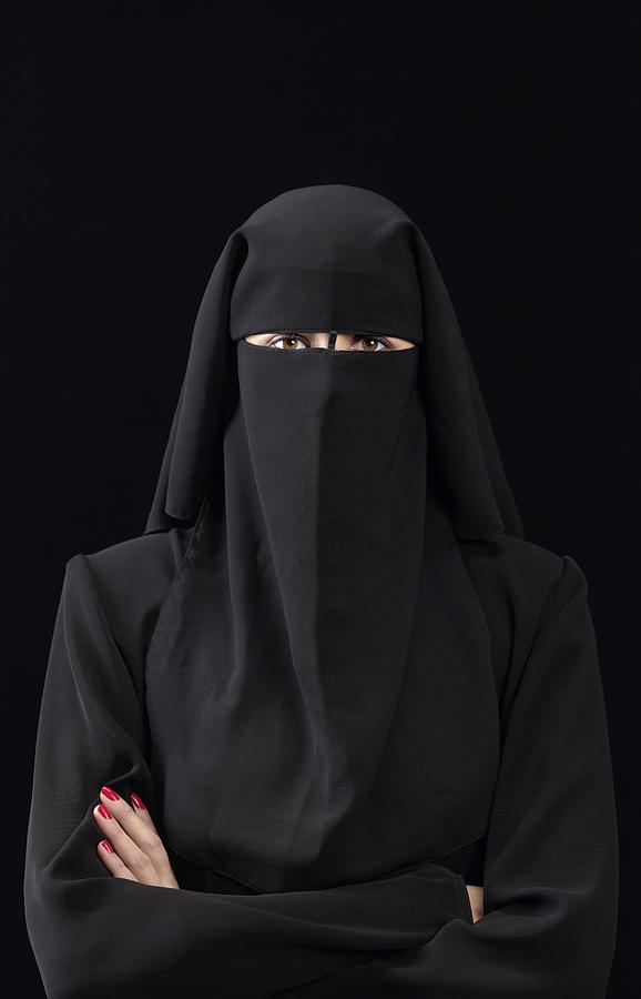 Woman in burka arms folded Photograph by Peter Dazeley