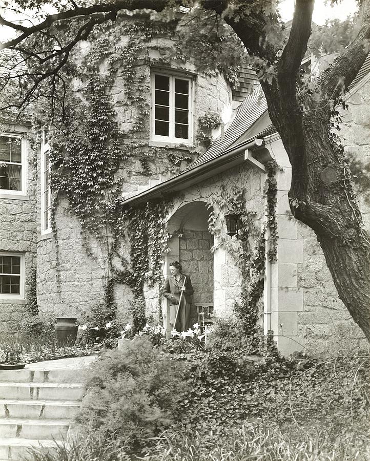 Woman In Doorway Of House Photograph by Peter Nyholm