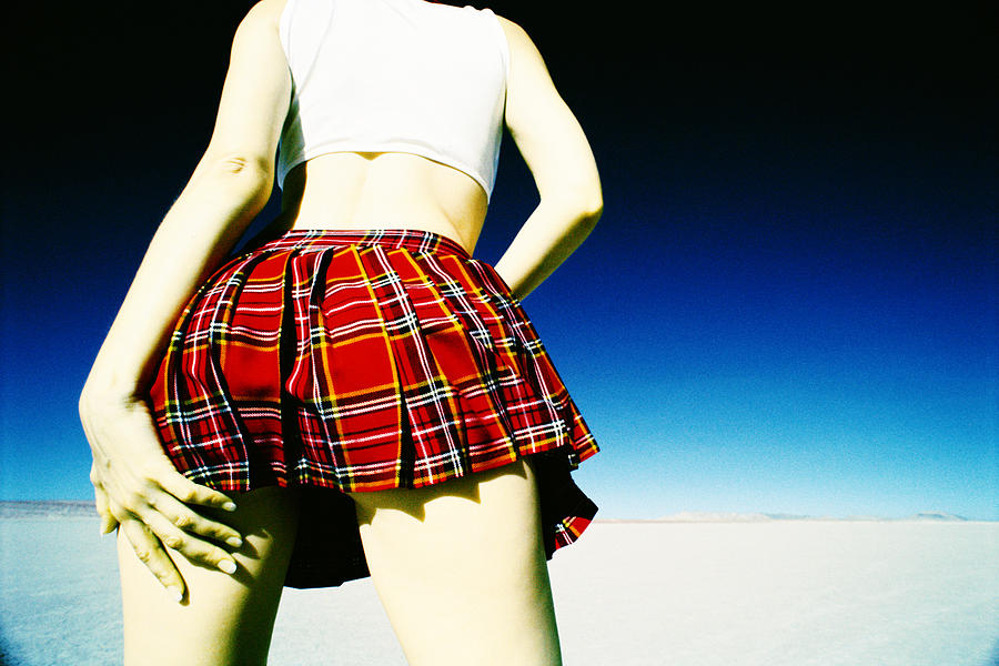 Woman in plaid skirt from behind Photograph by Thinkstock
