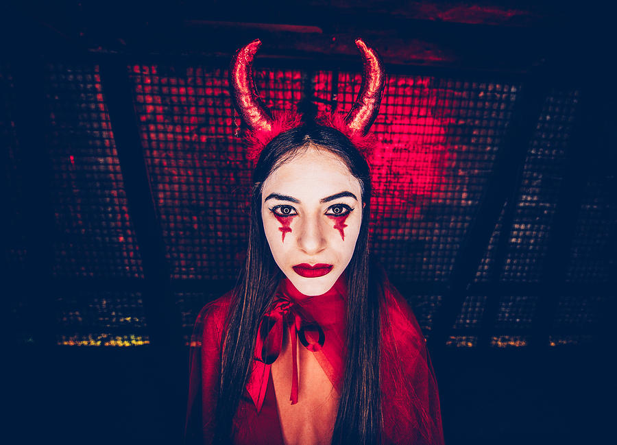 Woman in red devil costume and dramatic make-up for Halloween Photograph by Wundervisuals