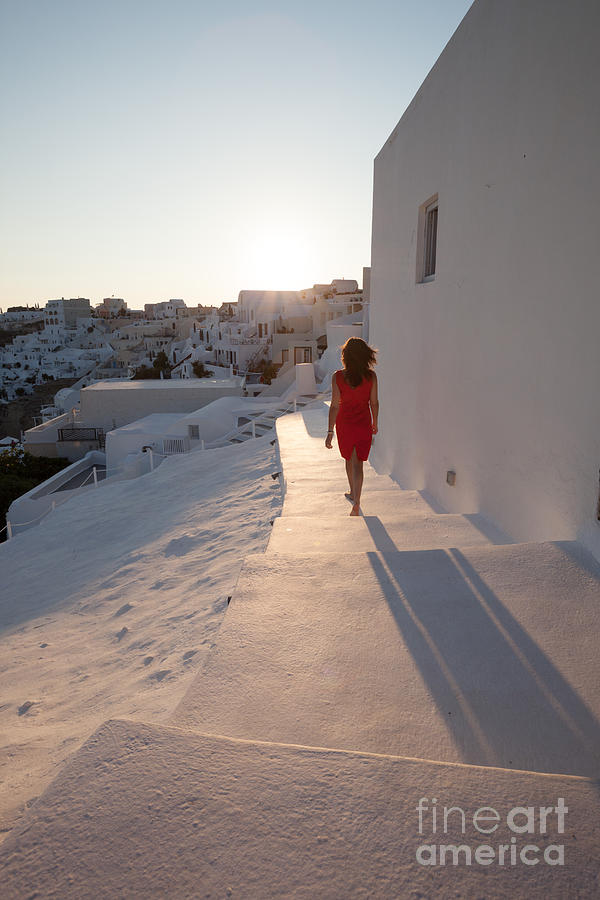 Woman in red in Oia - Santorini - Greece Photograph by Matteo Colombo