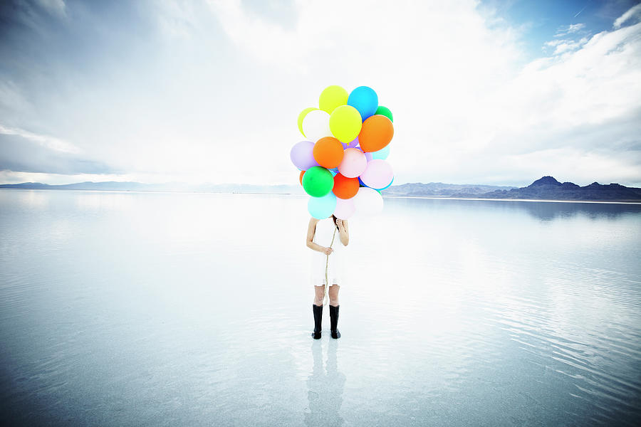 Woman In Water Standing Behind Balloons Photograph by Thomas Barwick