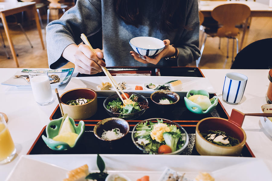 Woman is having meal in a Japanese restaurant Photograph by D3sign