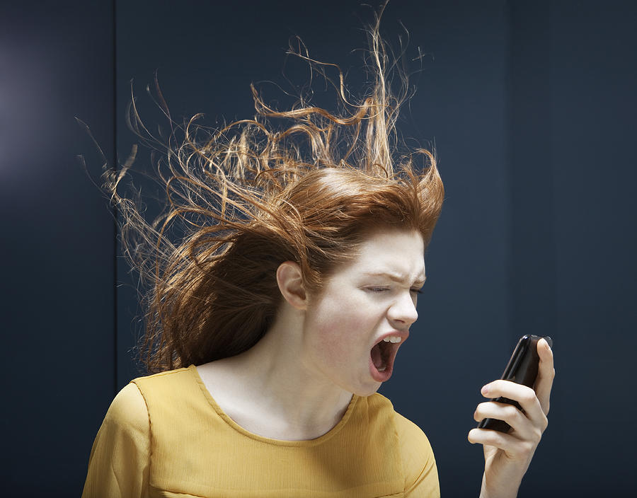 Woman Is Shouting Into Phone. Photograph by Betsie Van der Meer