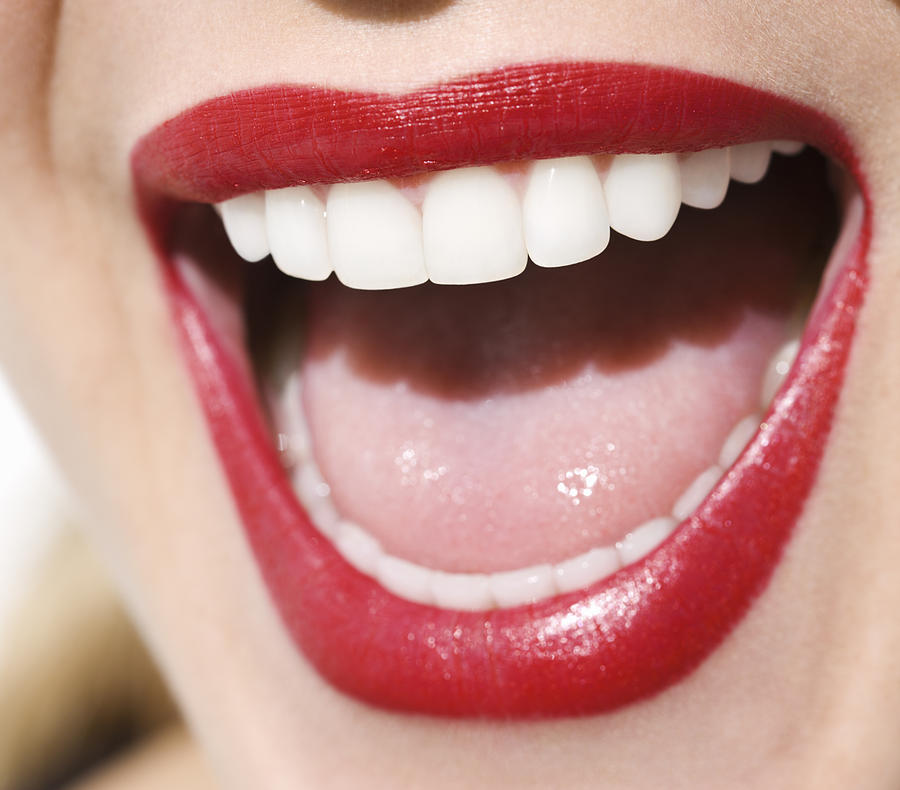 Woman laughing, close-up of mouth, red lips Photograph by Pando Hall