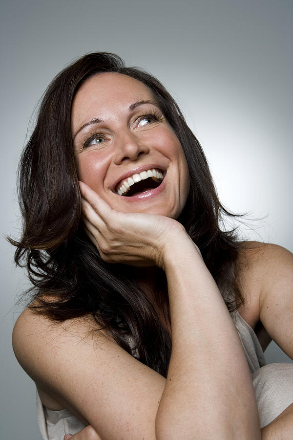Woman laughing, close-up Photograph by Ralf Nau