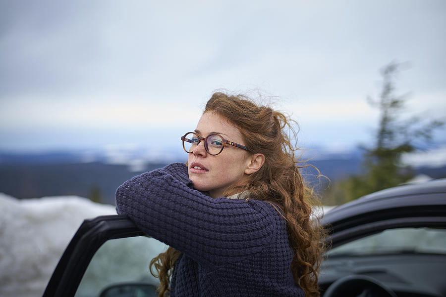 Woman Leaning On Her Car Door Overlooking Landscape While Having A Break From Driving Photograph by Justin Case