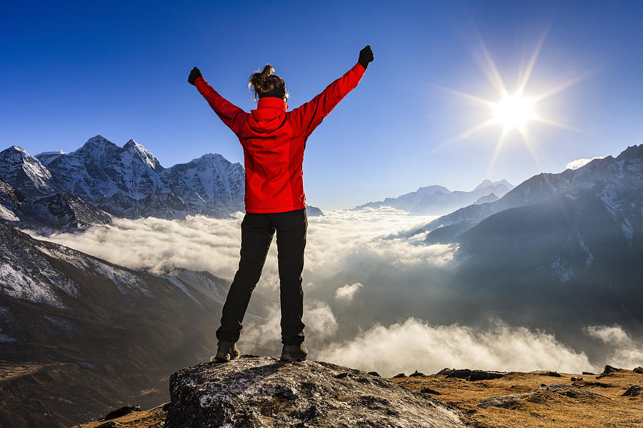 Woman lifts her arms in victory, Mount Everest National Park Photograph by Hadynyah