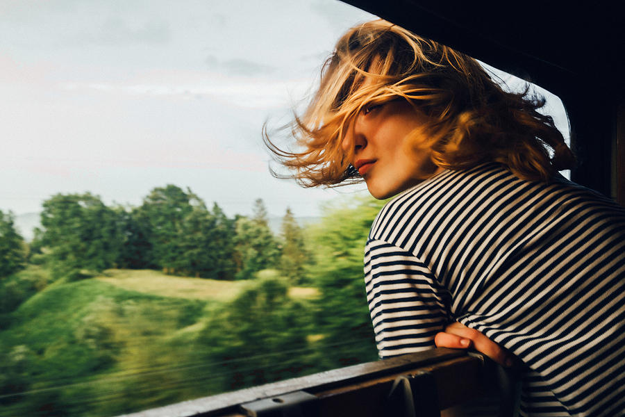 Woman looking at the view from train Photograph by Oleh_Slobodeniuk