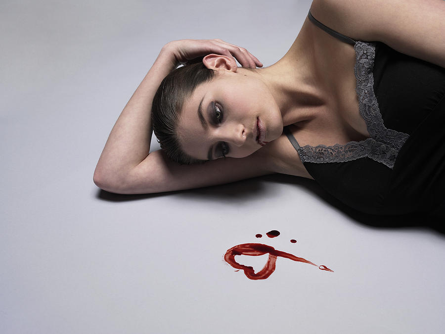 Woman lying dead on floor by heart shape drawn by blood Photograph by Andy Reynolds